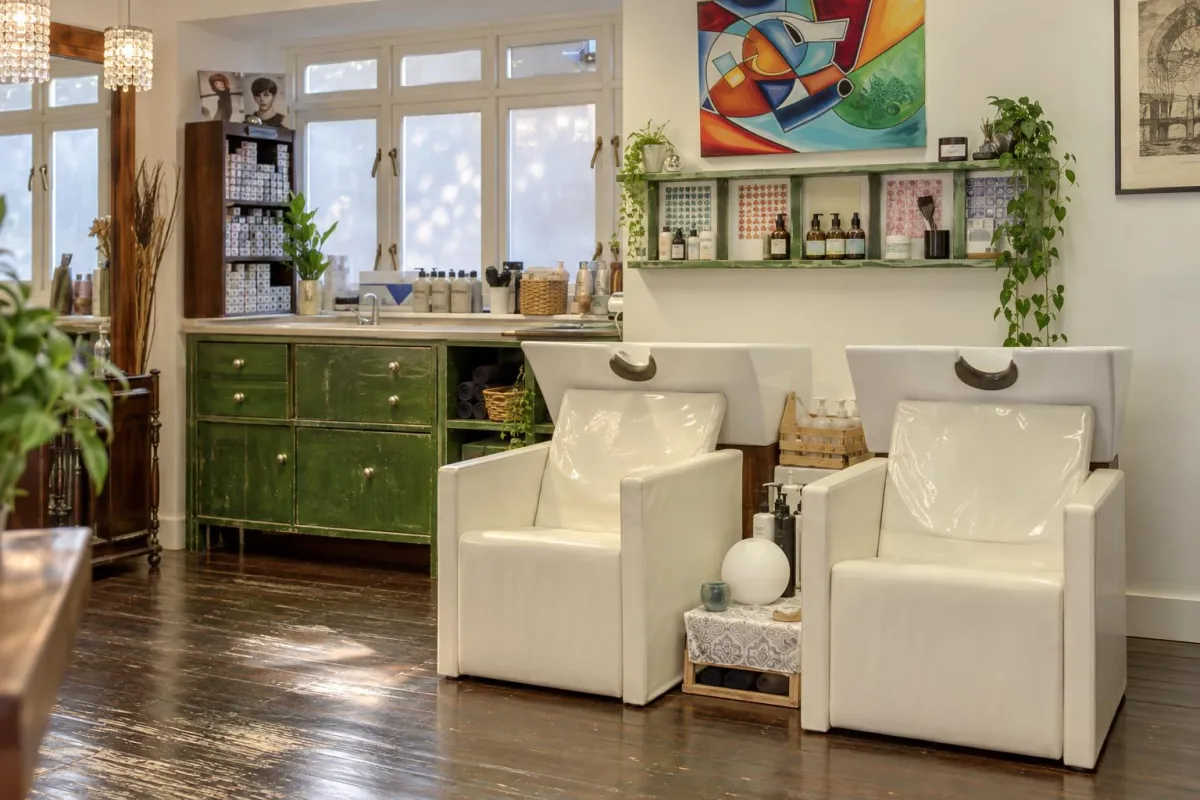 The wash area at Milano, with white basins and a green cabinet