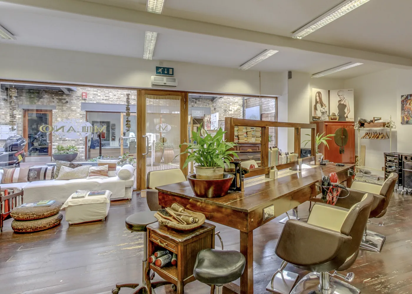 Inside Milano: the waiting sofa by the mews window and the wooden styling table