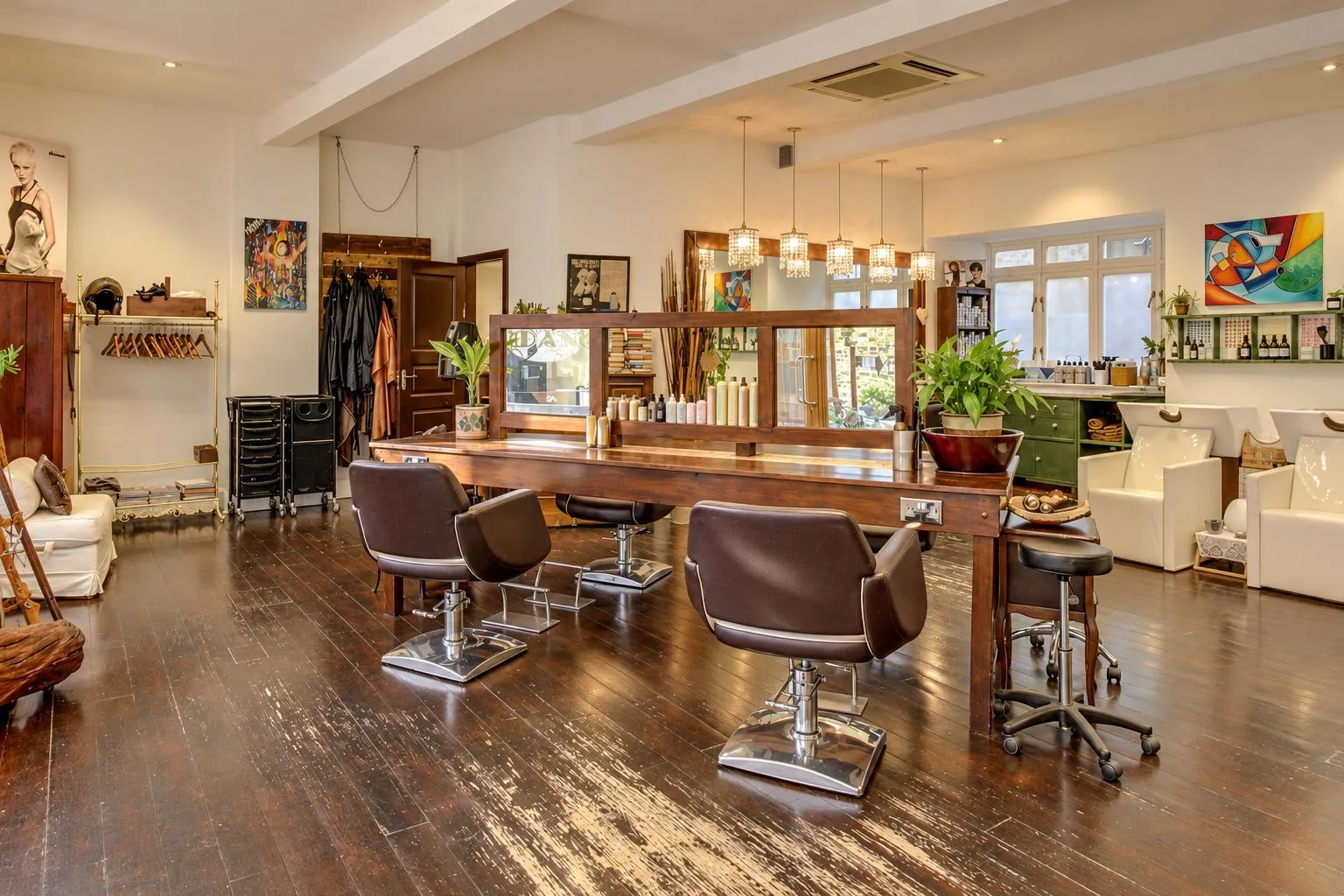 Inside Milano Hair & Beauty: the long wooden styling table, leather chairs and crystal lights